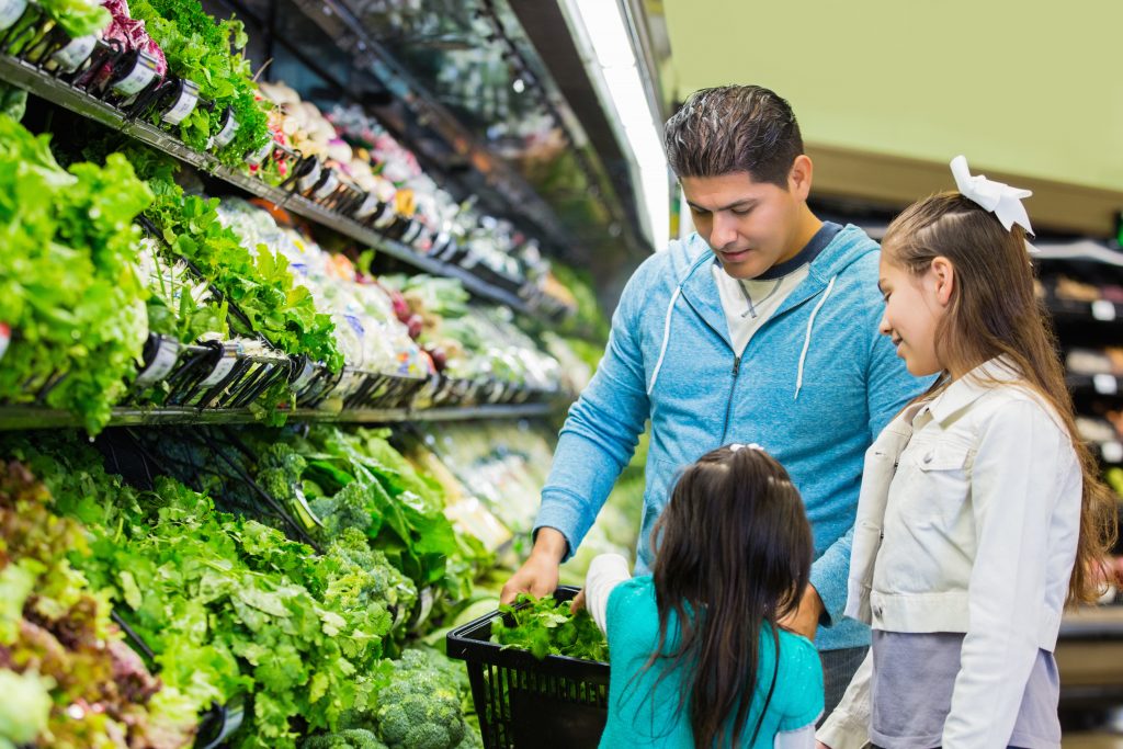 Father and daughters grocery shopping