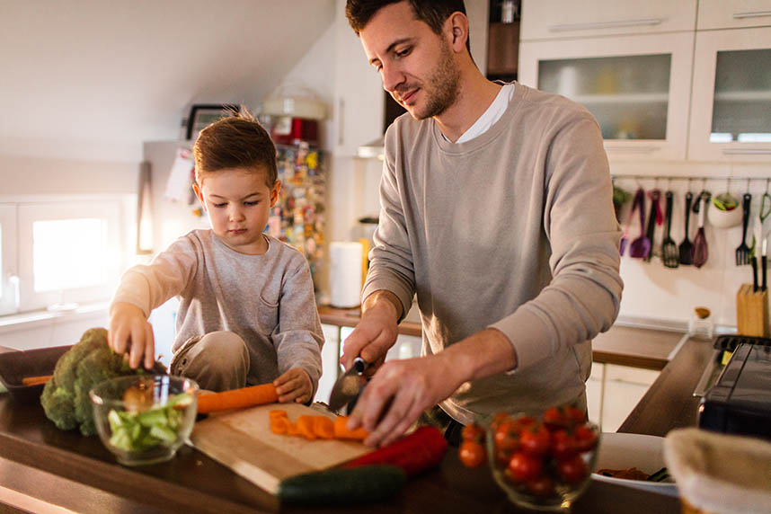 Father and son preparing healthy food in the kitchen