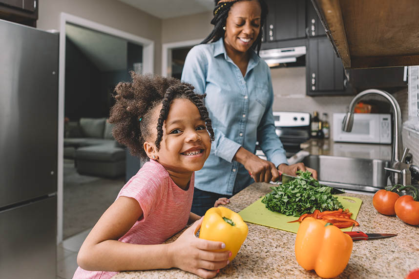 Mother and daughter making a salad