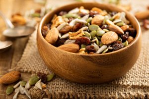 Wooden bowl of seen and nut snack mix
