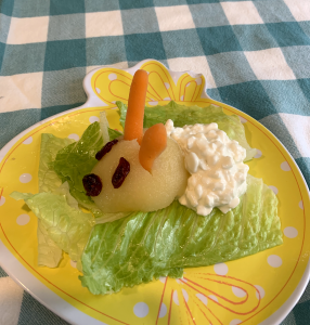 Bunny recipe on a yellow rabbit plate sitting on a blue checkered tablecloth