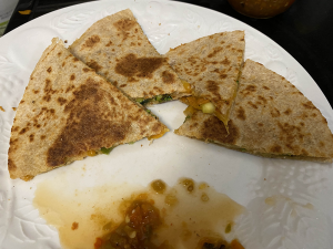 sliced quesadilla on a plate with salsa