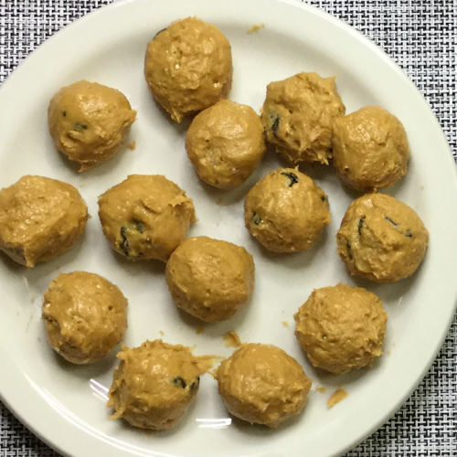 rolled peanut butter balls on white plate