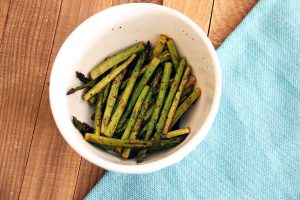 Roasted asparagus in a white bowl