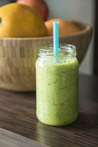 Green smoothie in glass jar.