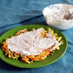 Cabbage pancake with yogurt sauce on a green plate