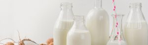 Variety of milk and milk alternatives in glass bottles