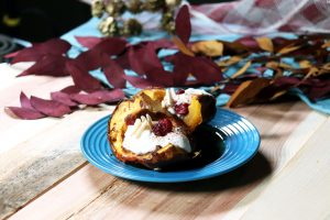 Acorn squash topped with yogurt, cranberries and slivered almonds