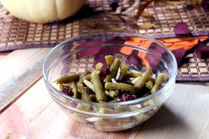 bowl of green beans, cranberries, and nuts