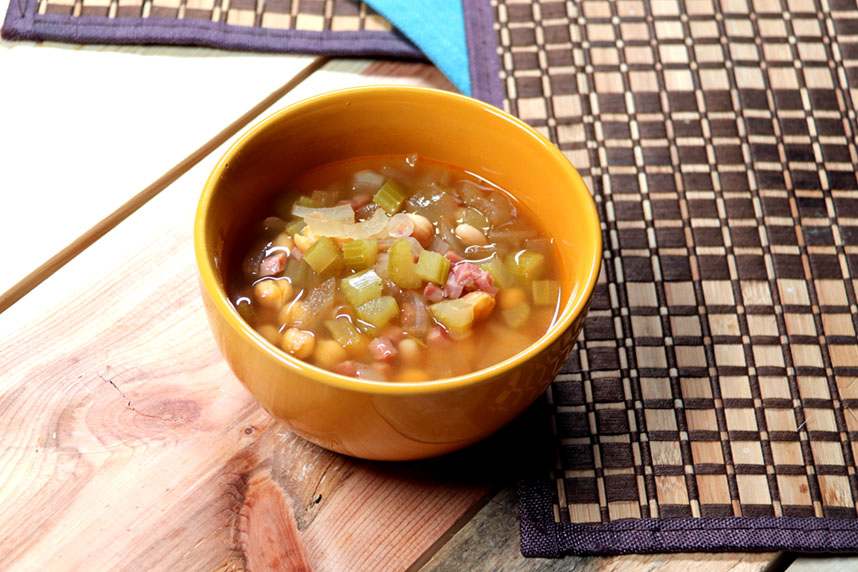Bowl of bean soup with ham, onions, and celery