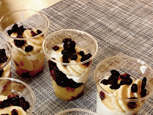 Parfaits with layered yogurt and fruit in clear cups on counter