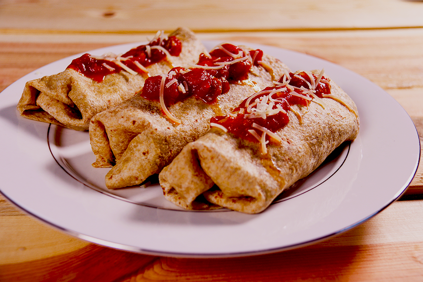 3 burritos topped with salsa and cheese on plate