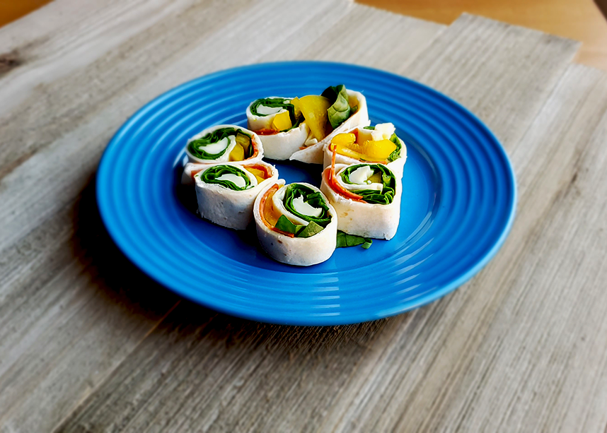 Pizza Pinwheels on plate with wood background