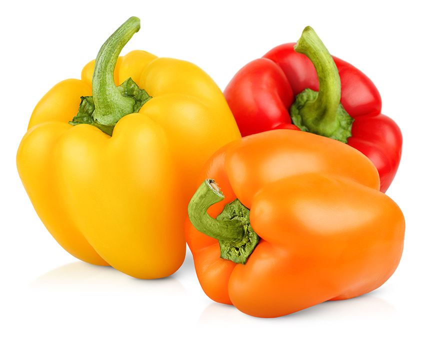 Yellow, red, and orange bell peppers on a white background
