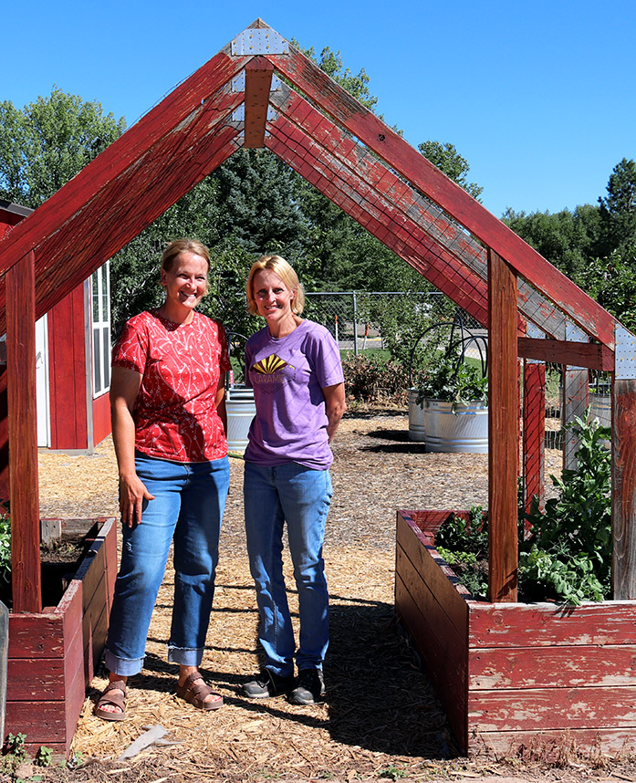 Ruth Lake and Stefanie Hunt under the growing arch at the Linford garden