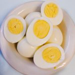 Hard boiled eggs cut in half to show the yellow center