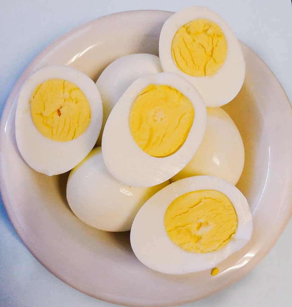 Hard boiled eggs cut in half to show the yellow center