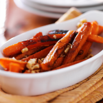 White baking dish of roasted carrots