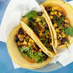 Bean and corn tacos on a blue background