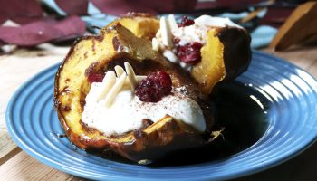 Acorn squash topped with yogurt, cranberries and slivered almonds