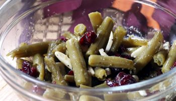 green beans with cranberries and slivered almonds in bowl