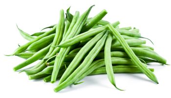 Pile of fresh green beans on a white background